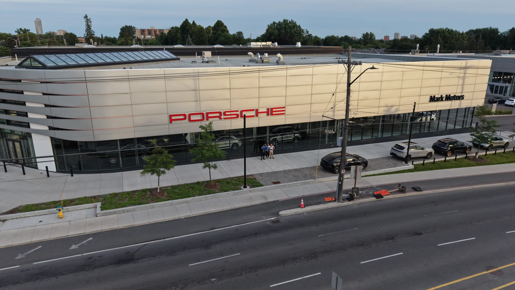 Aerial view of a commercial building and its road frontage.