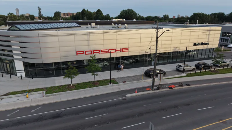Aerial view of a commercial building and its road frontage.