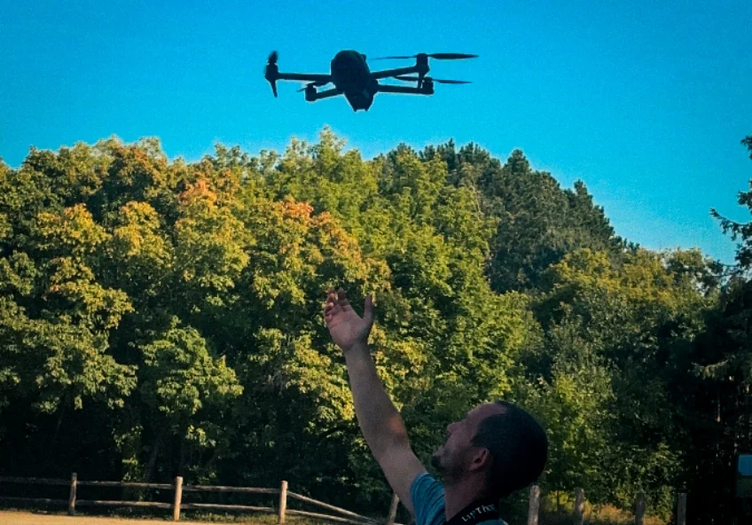Stan Kozniewski with a drone outdoors.